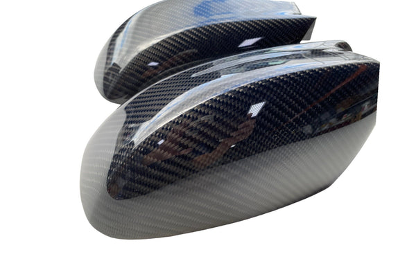Carbon fiber side mirror covers for 2015–2023 Dodge Charger Widebody and Slim Body and 2011–2023 Chrysler 300, featuring glossy woven carbon fiber.