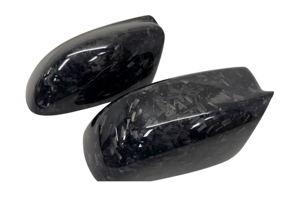 Handcrafted forged carbon fiber mirror covers for Dodge Charger and Chrysler 300, showcasing sculpted contours and glossy marbled carbon finish.